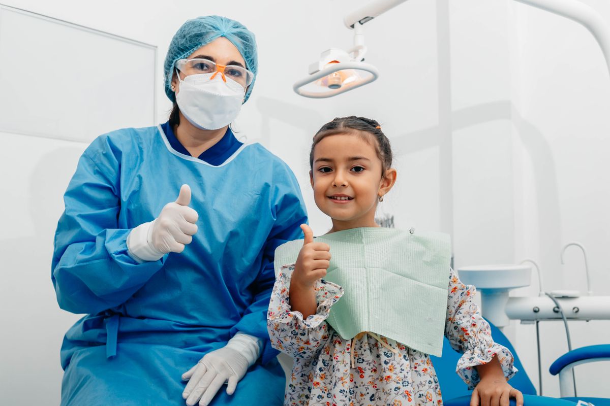 A dentist and a young patient after a check-up